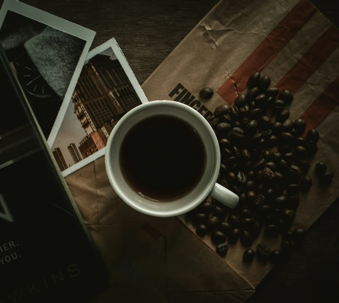 white ceramic mug on black and white table